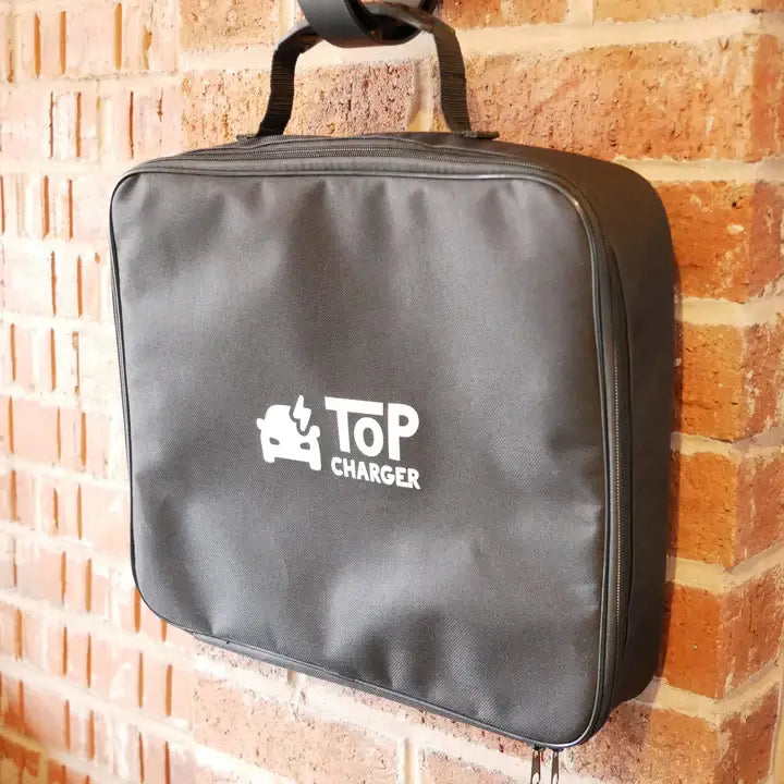 The EV cable carry bag shown hung up against a brick wall